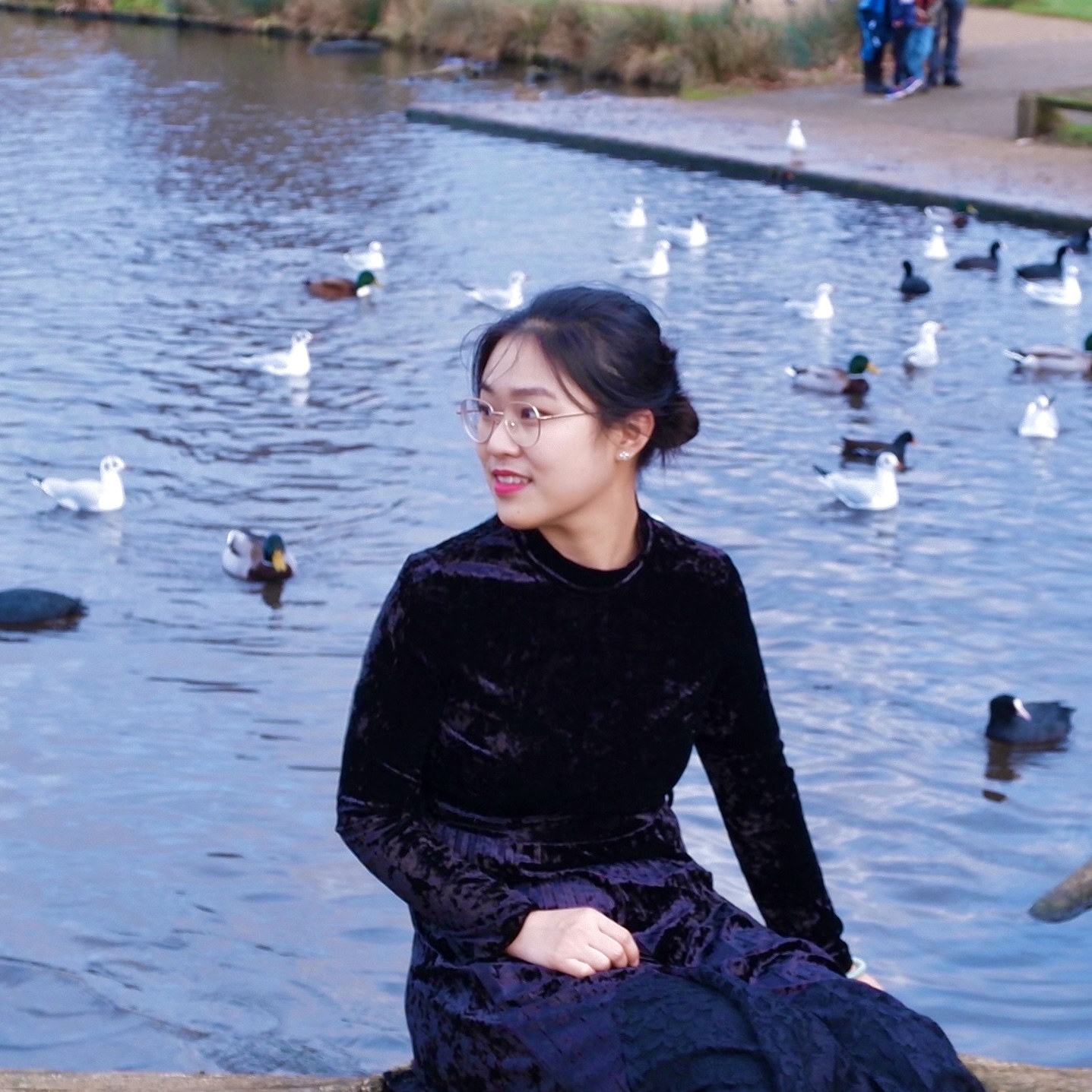 girl smiling wearing black velvet dress